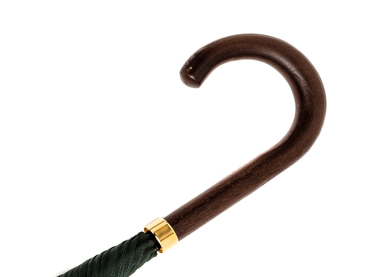 Dark brown wood handle of tube Fox Umbrella with dark green canopy