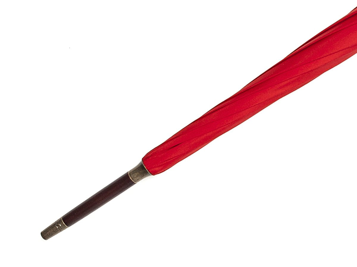 Tip end of dark brown wood handle tube Fox Umbrella with red canopy