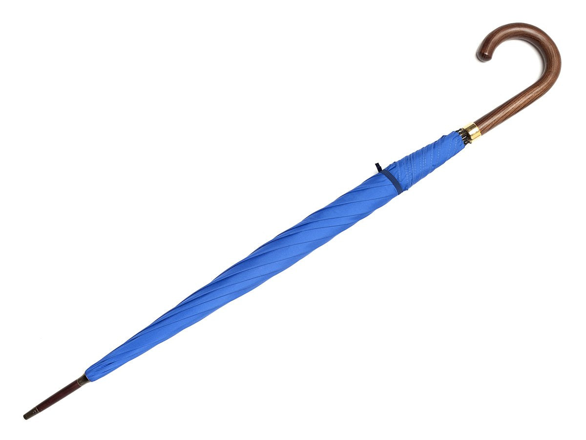 Full length view of dark brown wood handle tube Fox Umbrella with royal blue canopy