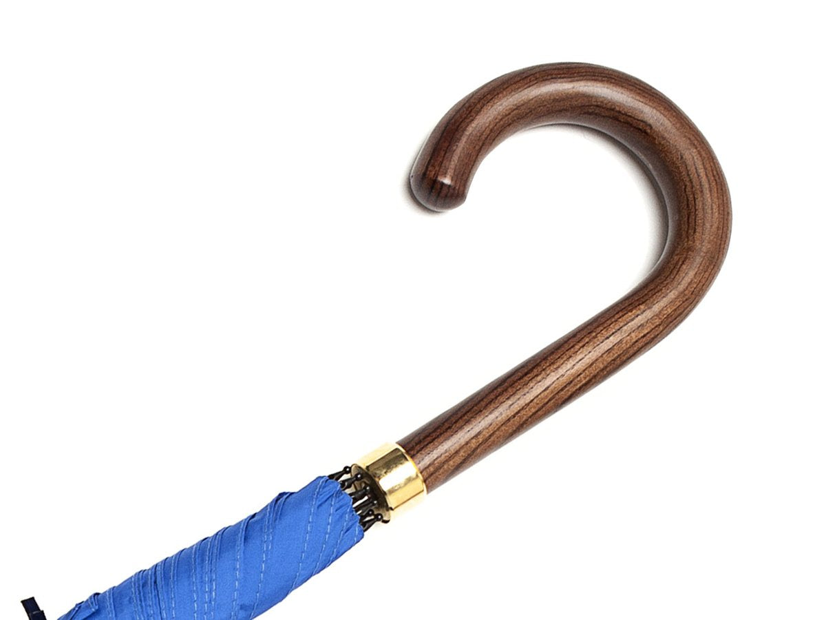 Dark brown wood handle of tube Fox Umbrella with royal blue canopy