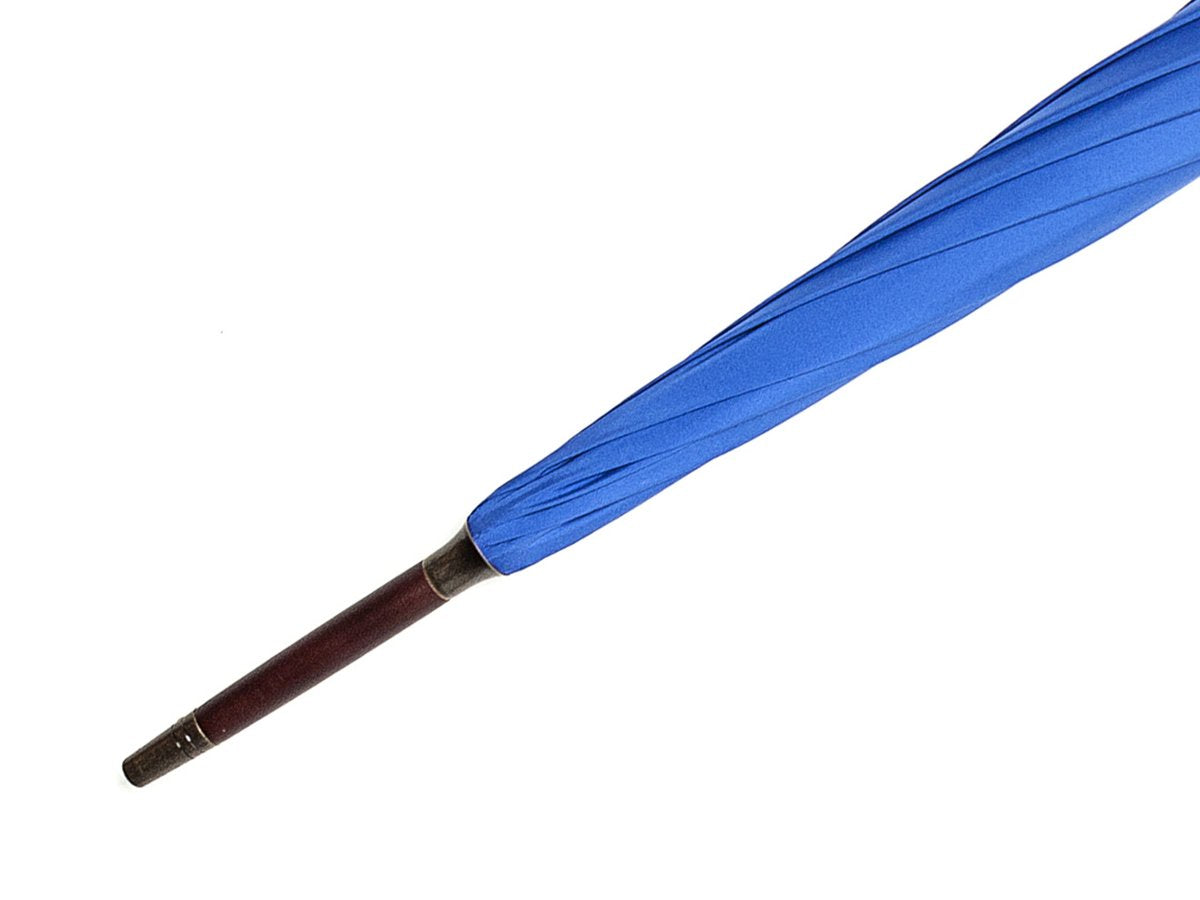 Tip end of dark brown wood handle tube Fox Umbrella with royal blue canopy
