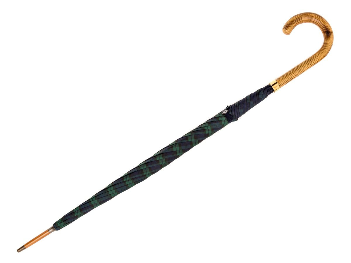 Full length view of light grain wood handle tube Fox Umbrella with black watch tartan canopy