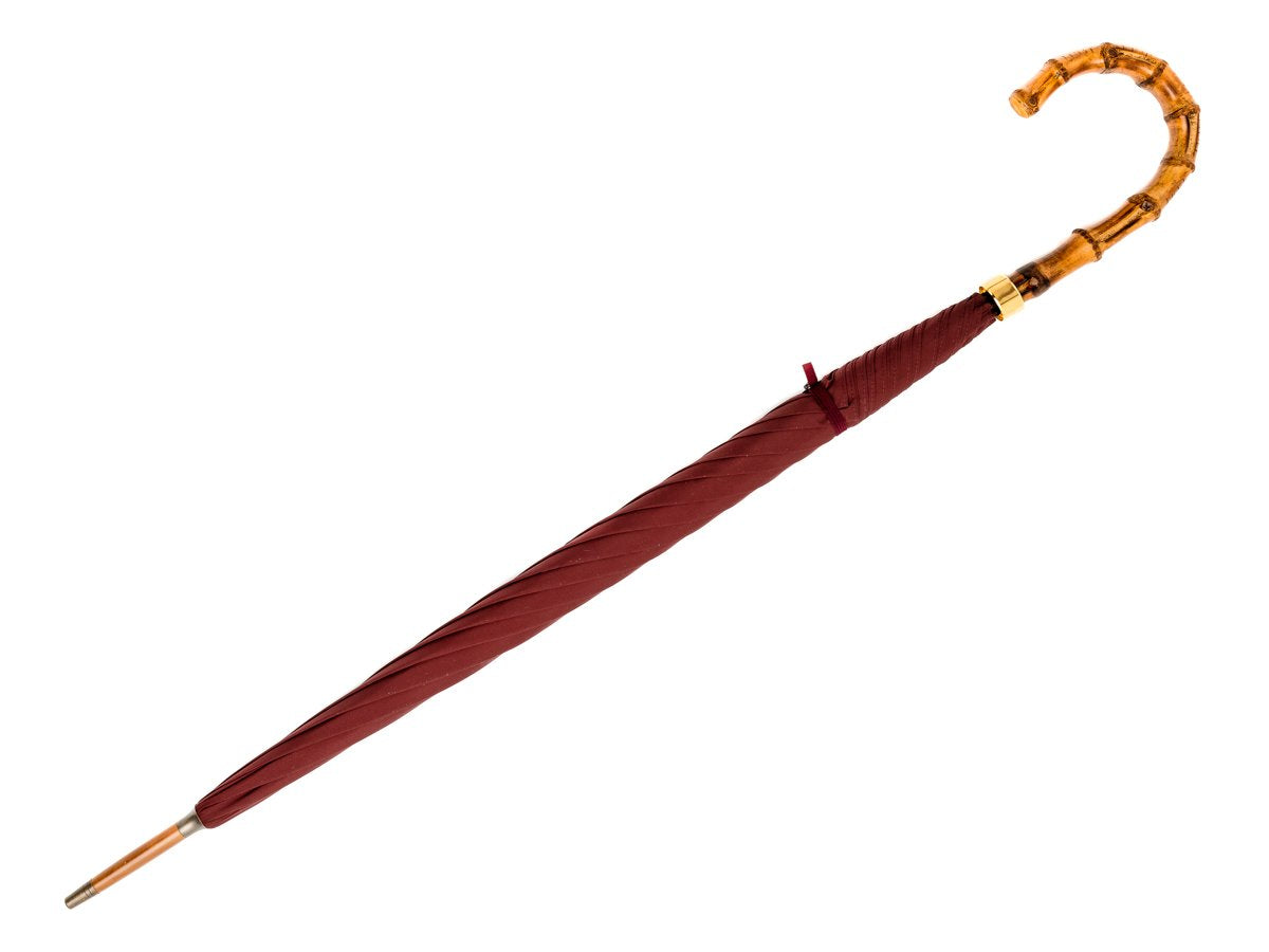 Full length view of whangee handle tube Fox Umbrella with burgundy canopy