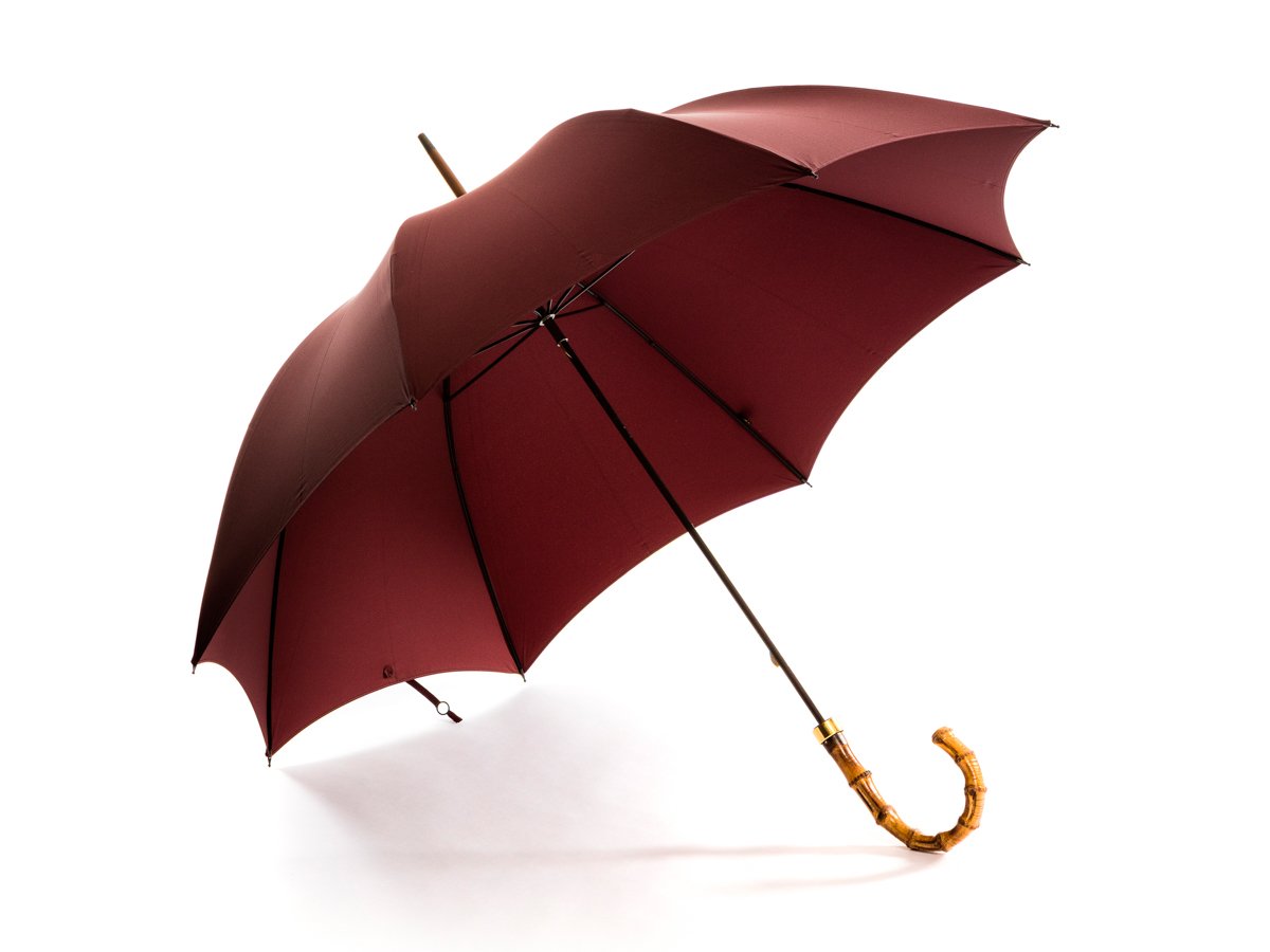 Opened whangee handle tube Fox Umbrella with burgundy canopy
