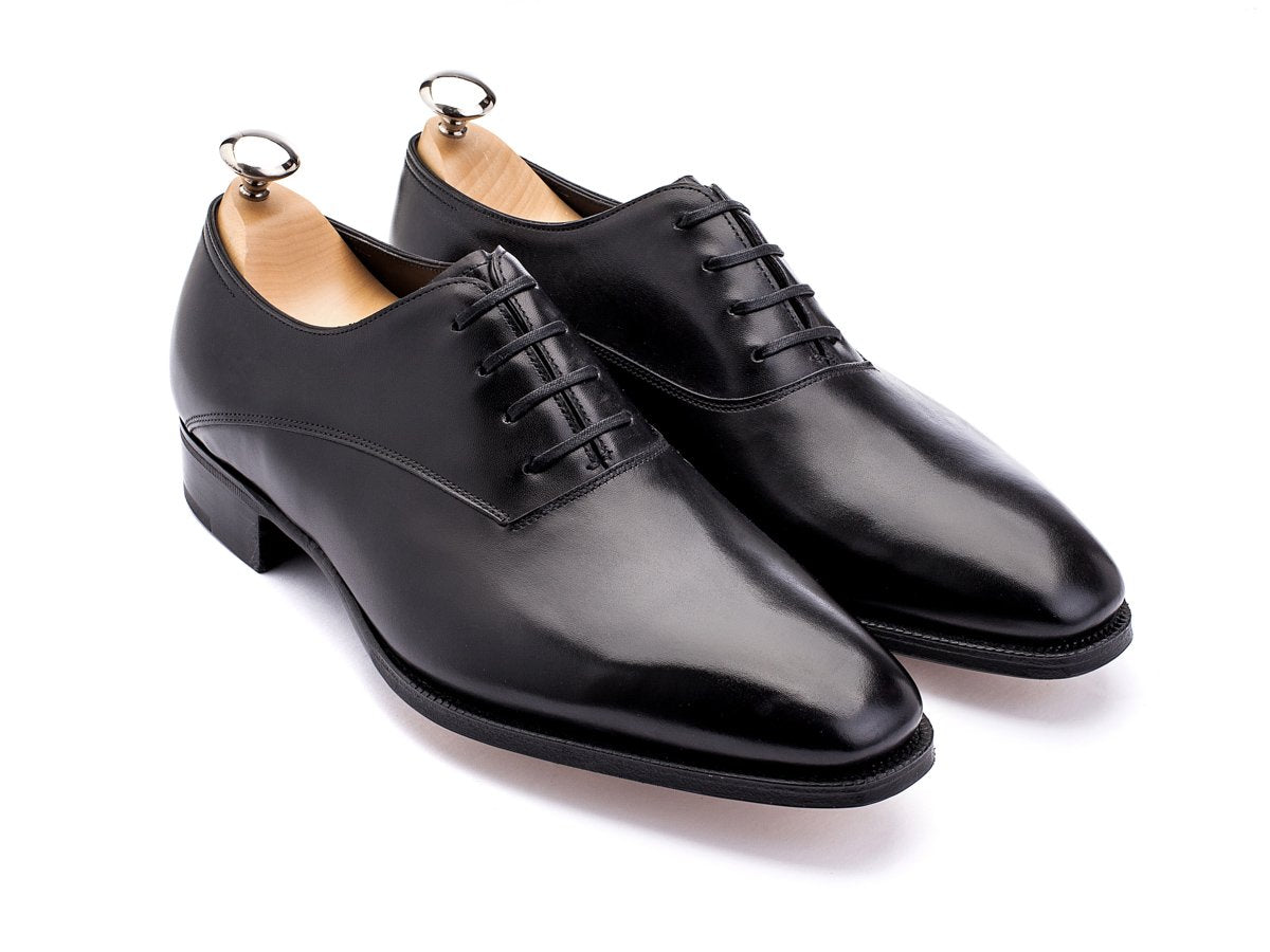 Front angle view of EE width John Lobb Beckett plain toe oxford shoes in black calf with shoe trees