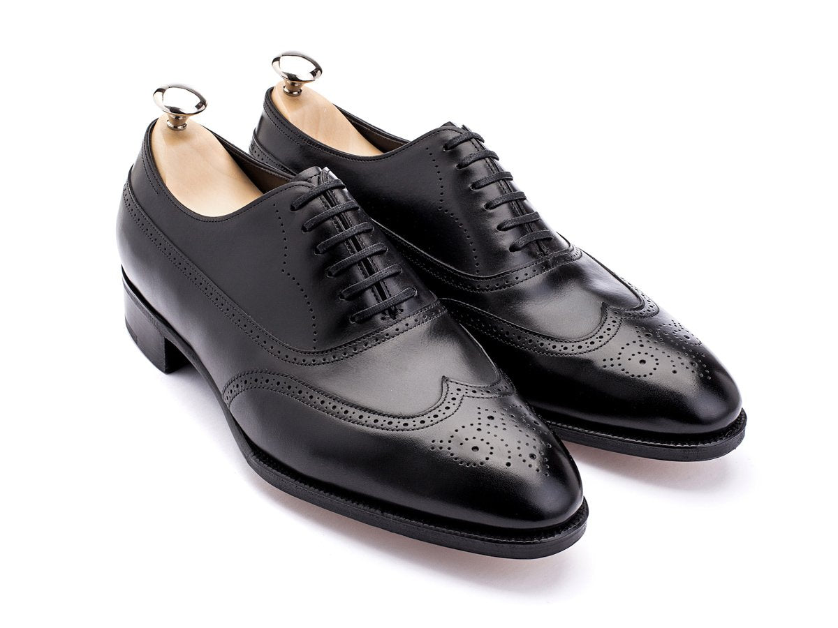 Front angle view of EE width John Lobb Cavendish wingtip full brogue balmoral oxford shoes in black oxford calf with shoe trees