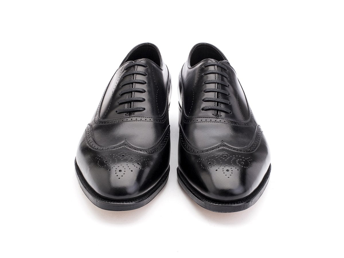Front view of EE width John Lobb Cavendish wingtip full brogue balmoral oxford shoes in black oxford calf
