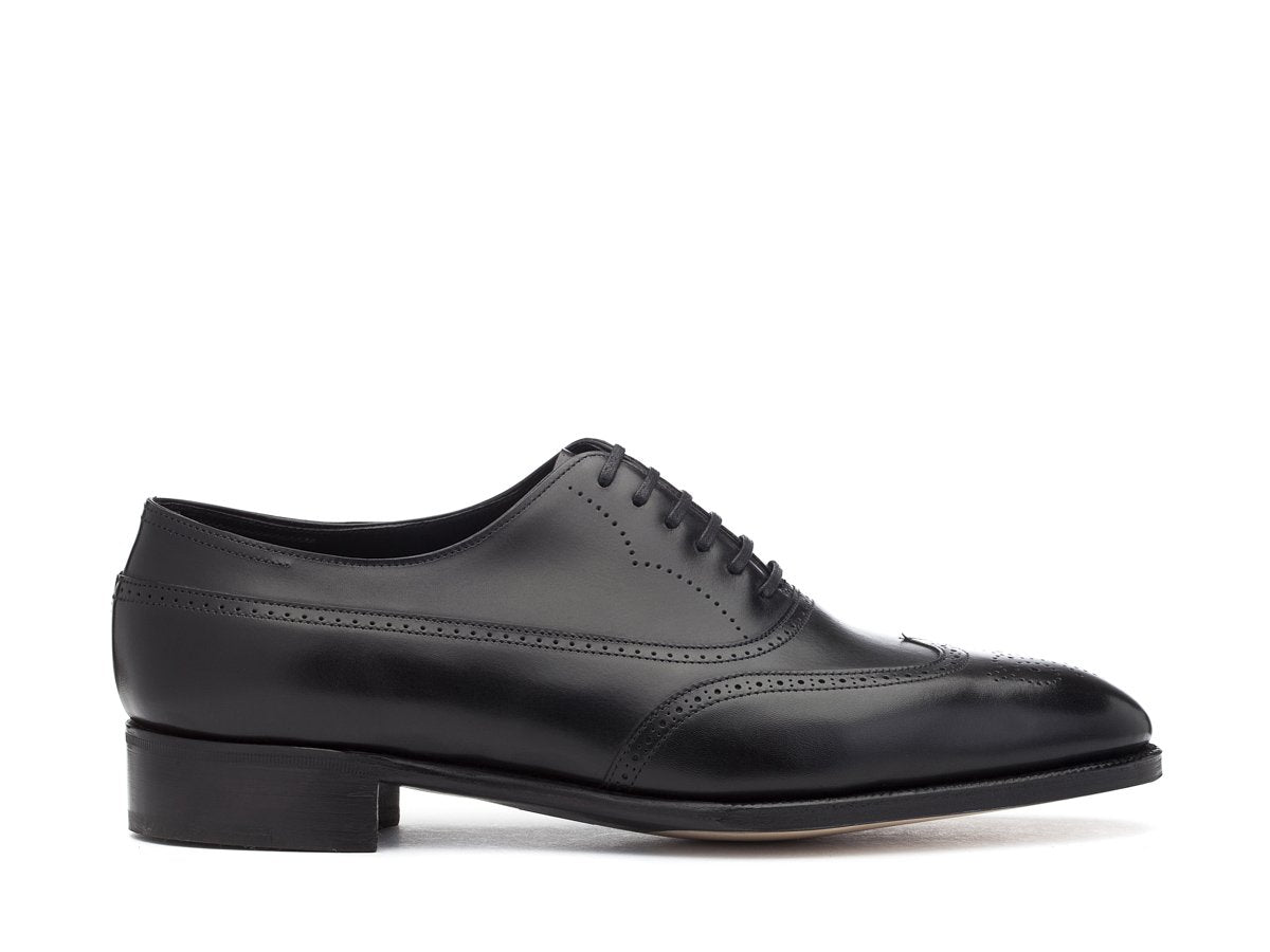 Side view of EE width John Lobb Cavendish wingtip full brogue balmoral oxford shoes in black oxford calf