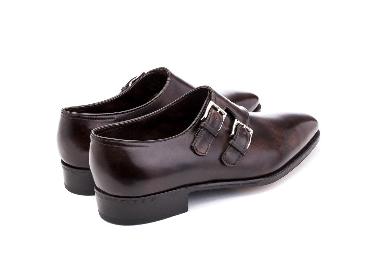 Back angle view of John Lobb Chapel plain toe swept back double monk strap shoes in dark brown museum calf