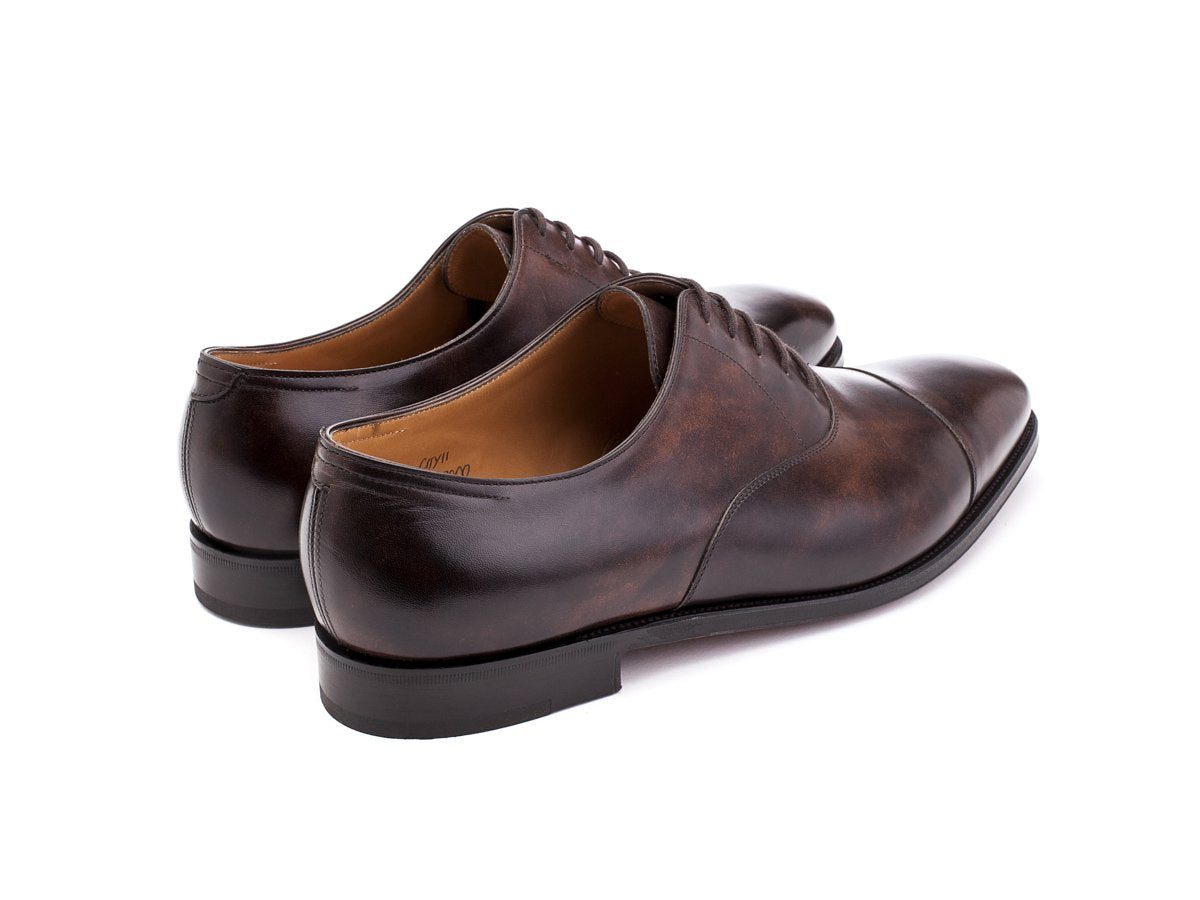 Back angle view of John Lobb City II plain captoe oxford shoes in dark brown museum calf