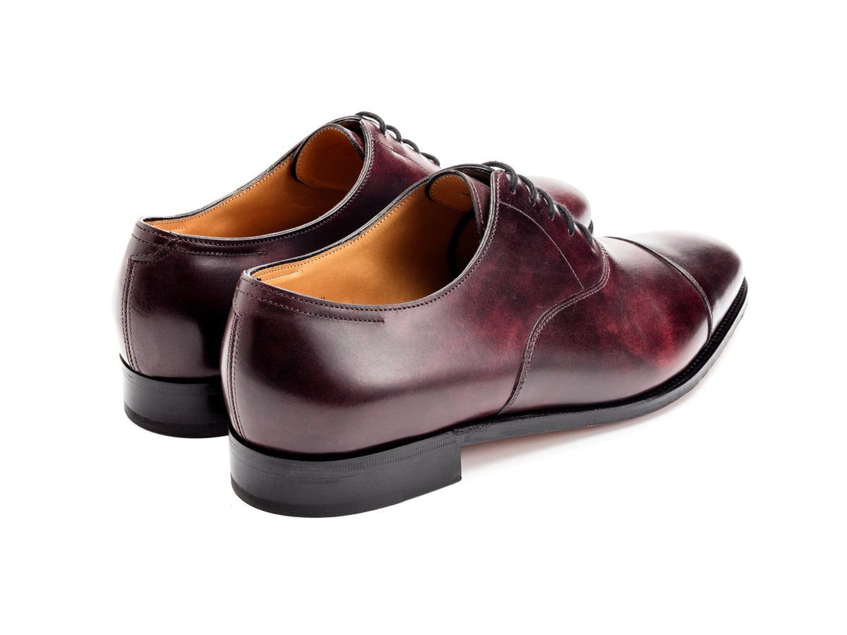 Back angle view of John Lobb City II plain captoe oxford shoes in plum museum calf