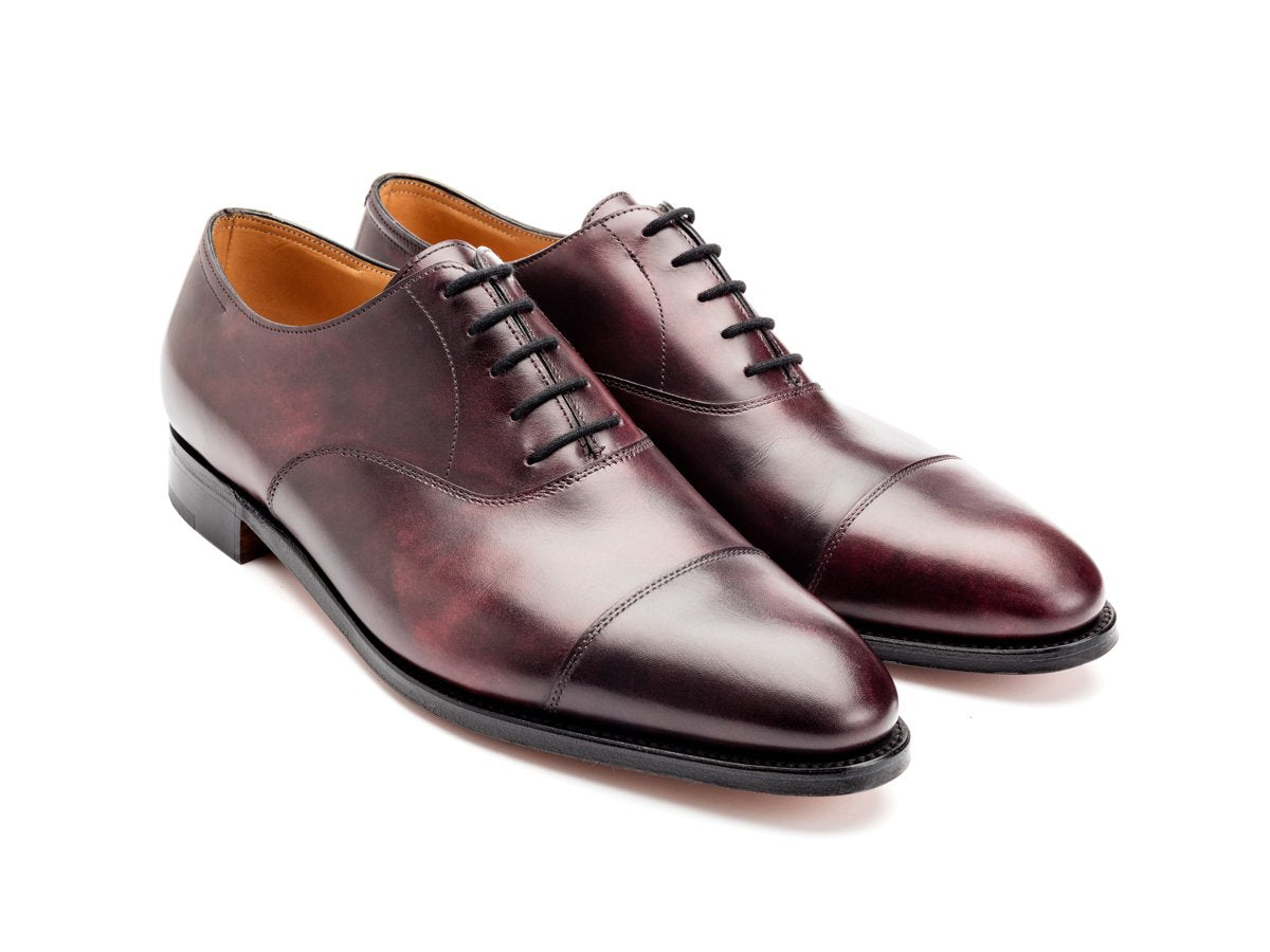 Front angle view of John Lobb City II plain captoe oxford shoes in plum museum calf