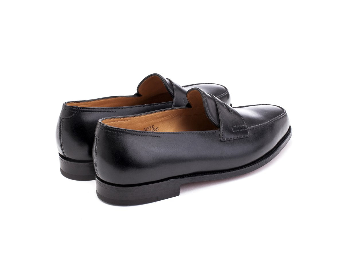 Back angle view of EE width John Lobb Lopez penny loafers in black calf