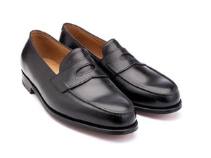 Front angle view of EE width John Lobb Lopez penny loafers in black calf