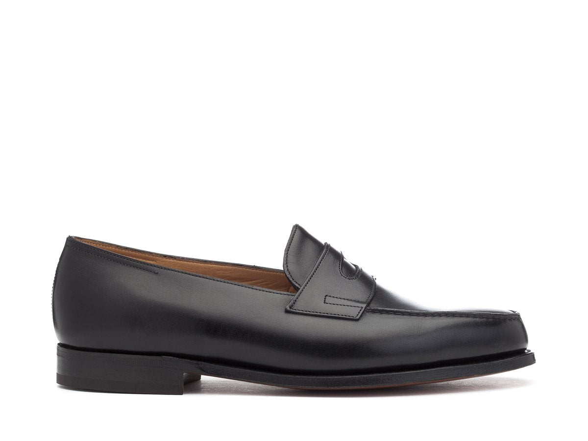 Side view of John Lobb Lopez penny loafers in black calf