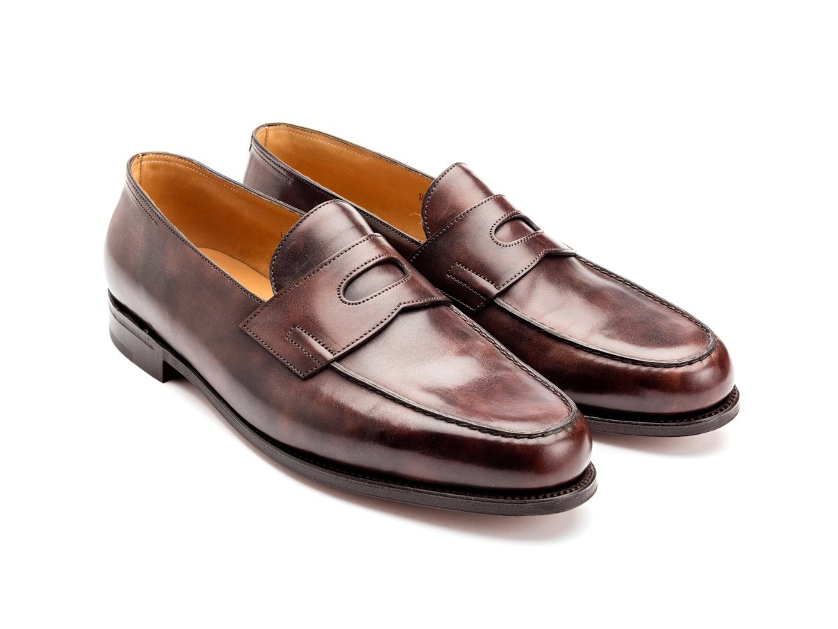 Front angle view of John Lobb Lopez penny loafers in dark brown museum calf