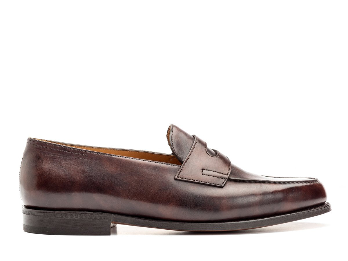 Side view of John Lobb Lopez penny loafers in dark brown museum calf