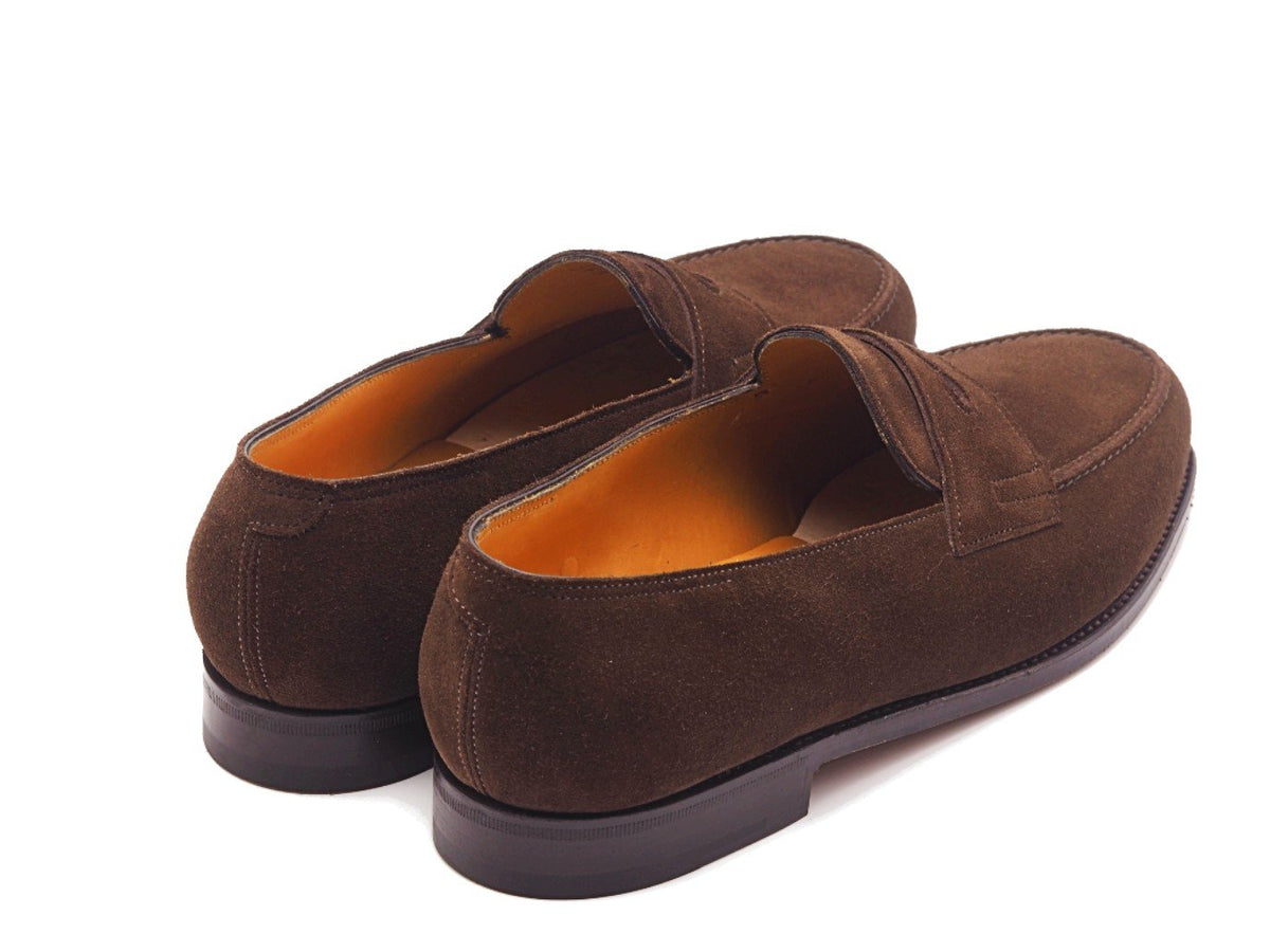 Back angle view of John Lobb Lopez penny loafers in dark brown suede