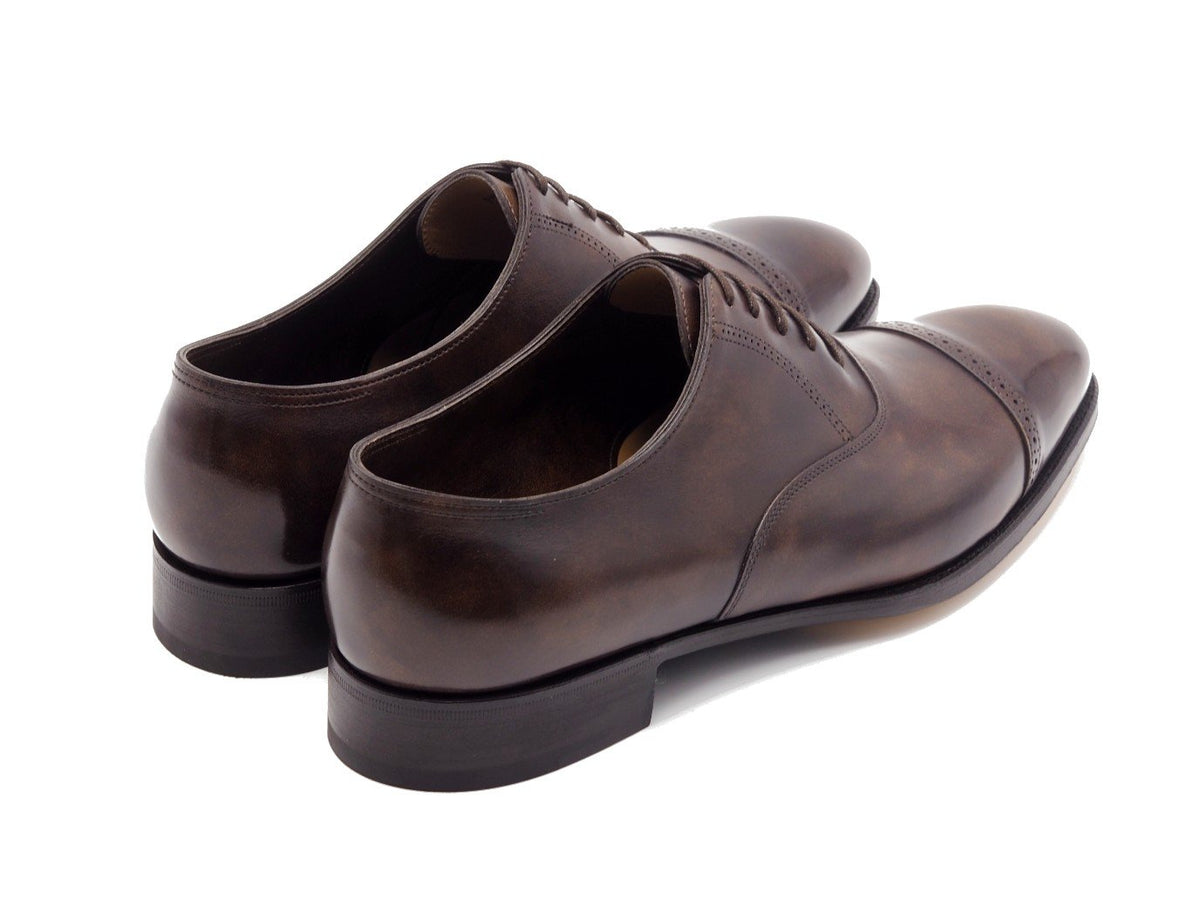 Back angle view of John Lobb Philip II quarter brogue oxford shoes in dark brown museum calf