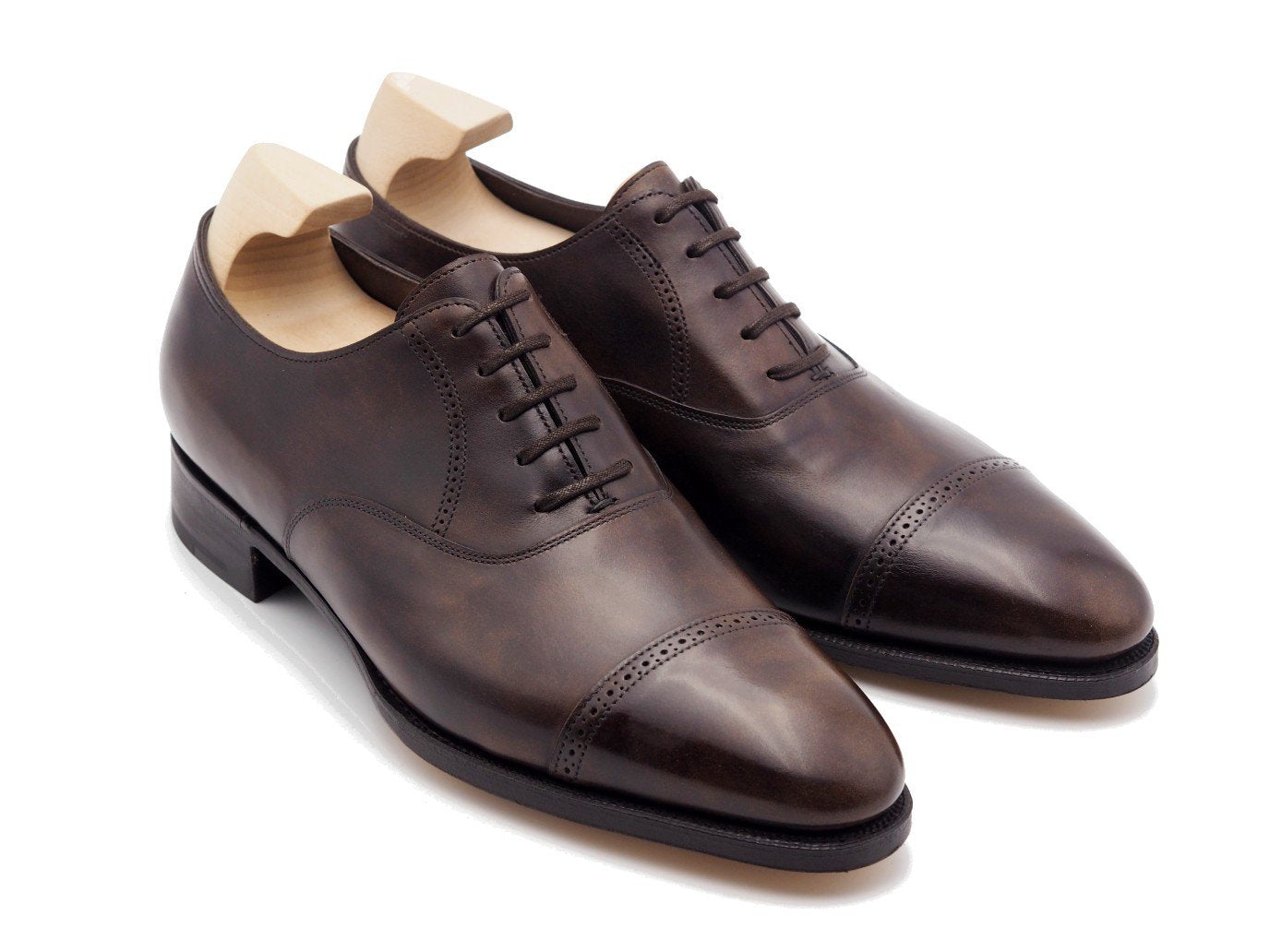 Front angle view of John Lobb Philip II quarter brogue oxford shoes in dark brown museum calf with shoe trees