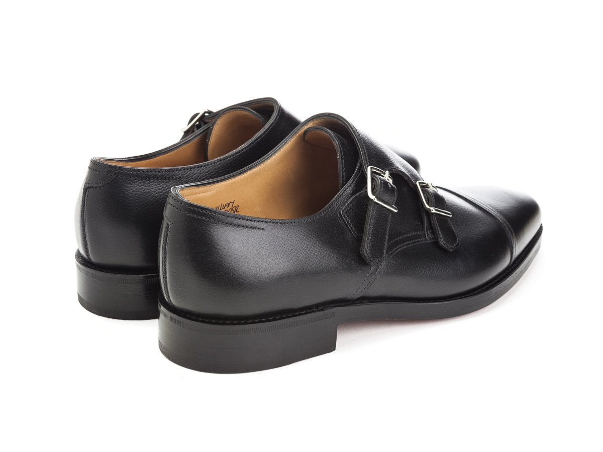 Back angle view of John Lobb William captoe double monk strap shoes in black buffalo calf