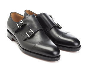 Front angle view of John Lobb William captoe double monk strap shoes in black buffalo calf