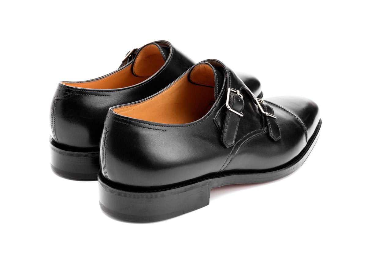 Back angle view of John Lobb William II captoe double monk strap shoes in black calf